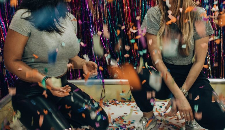 Two girls playing games in confetti