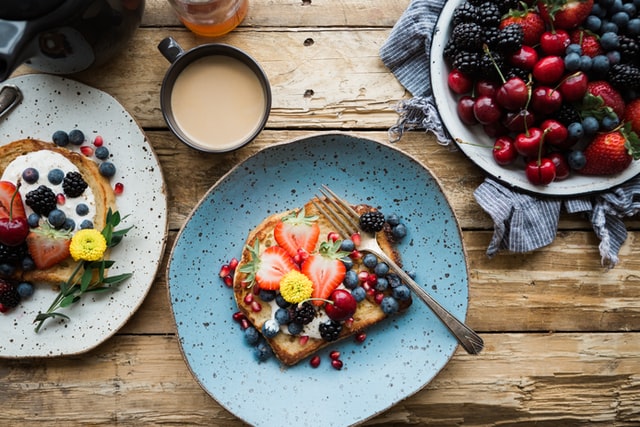 Plates of brunch food at a rustic table